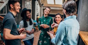five people smiling at house party