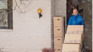 man moving boxes on a dolly