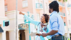 man and woman with clipboard looking at apartment