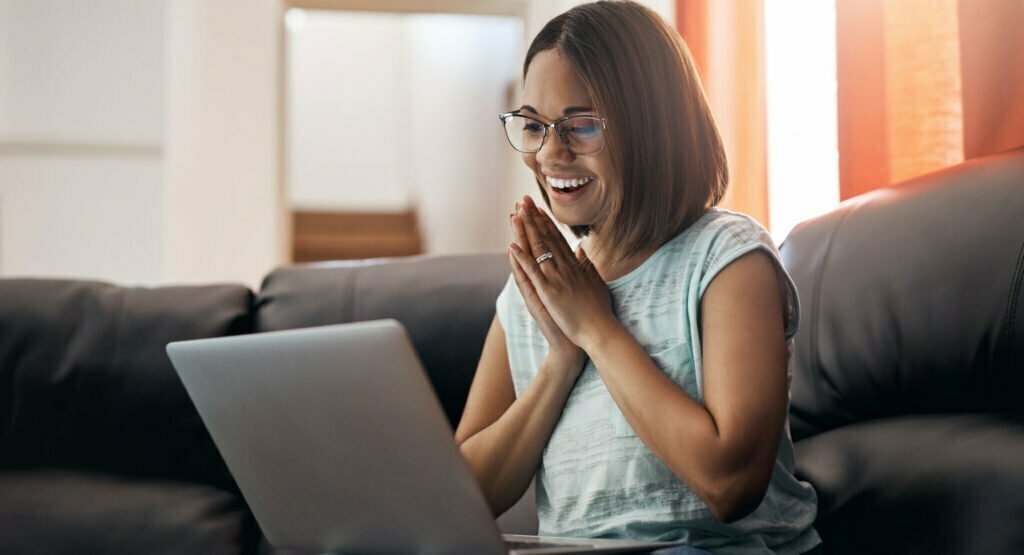 woman smiling at her laptop