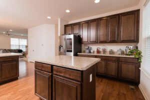 pristine kitchen with dark wooden cabinets