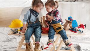 two little girls dressed as carpenters