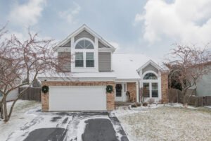 two story house covered in snow