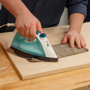 person steaming towel on wood