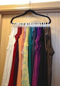 shirts hanging on a hanger in closet
