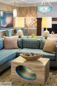 blue and tan living room with a busy design