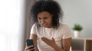 woman looking angrily at phone
