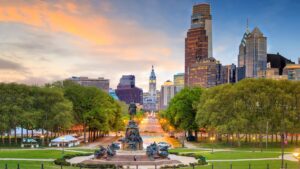 philadelphia skyline with statue and park