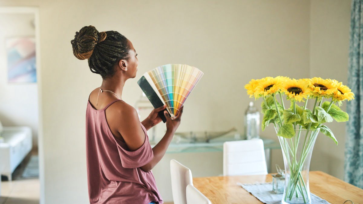 woman looking at color swatches in living room