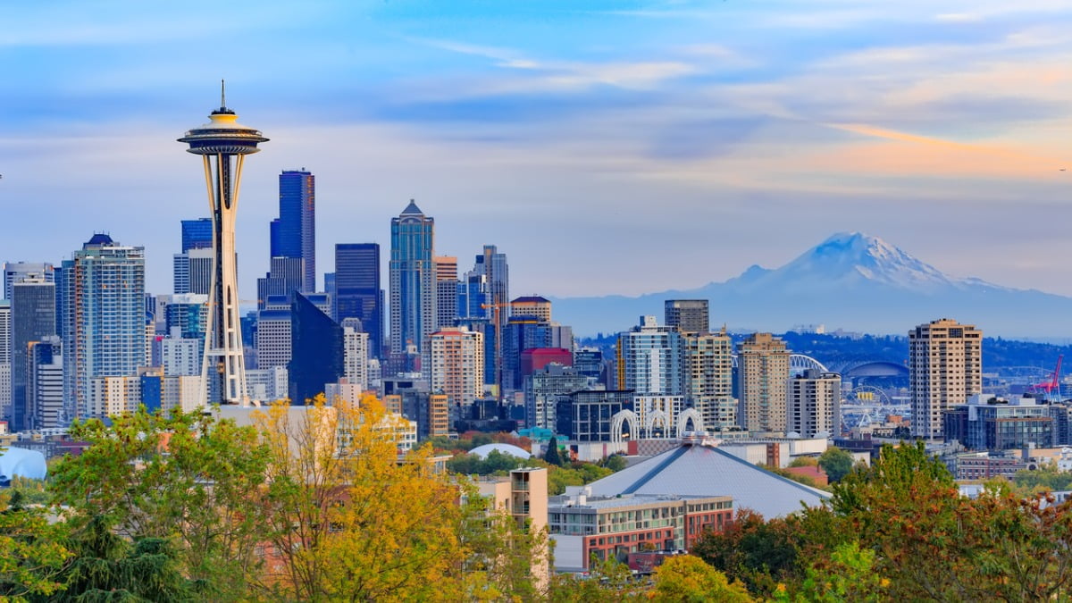 seattle skyline in front of snow capped mountains