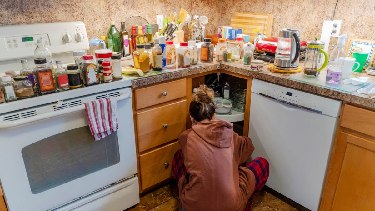 woman organizing cluttered kitchen