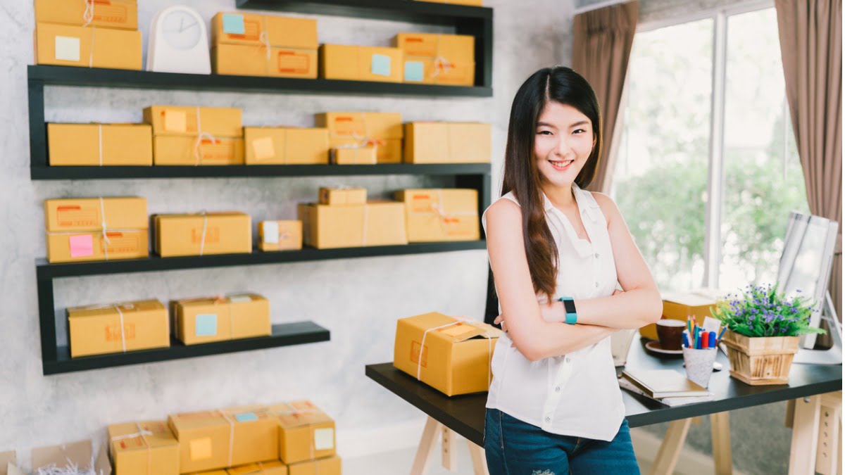 woman smiling in front of storage boxes