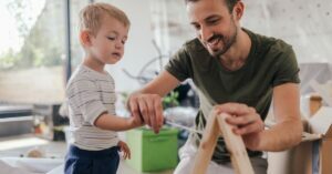father and son doing arts and crafts