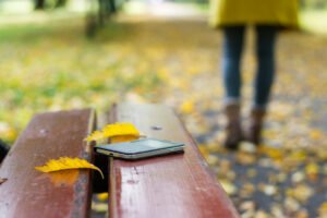 phone on bench in park