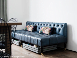 couch with storage boxes beneath it