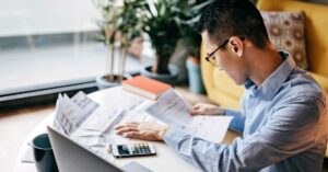 man organizing receipts