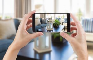 person taking picture of living room