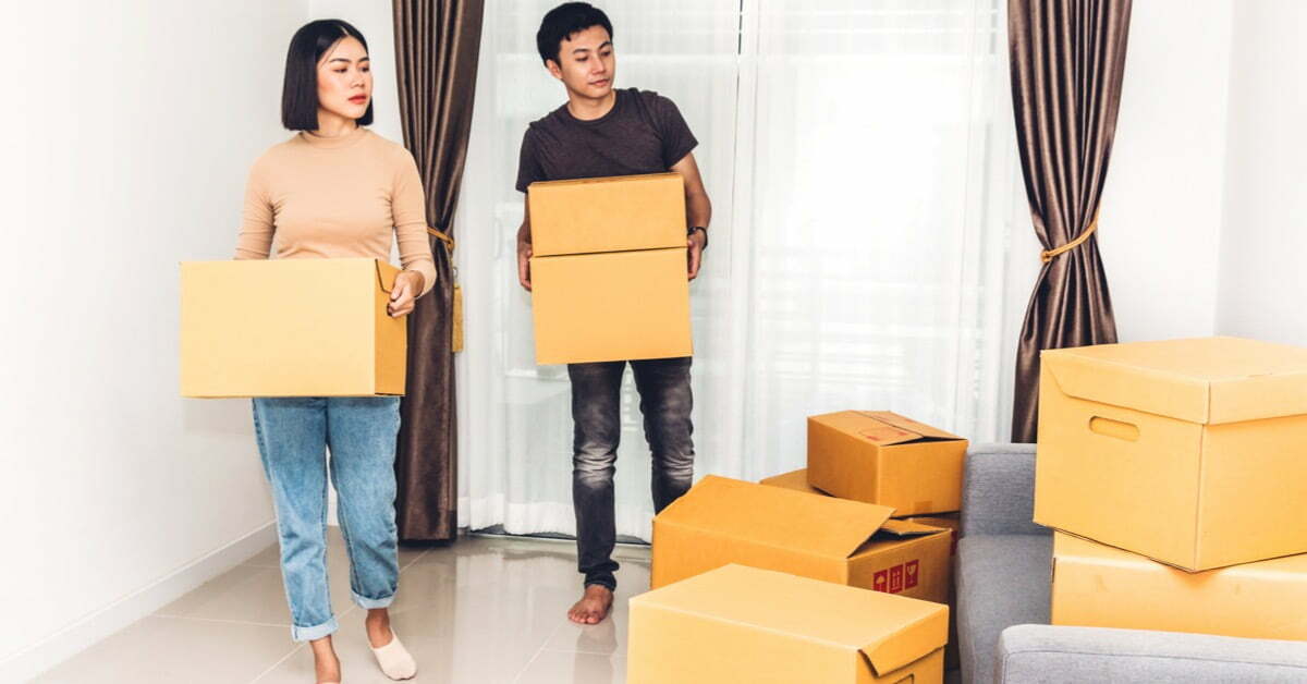 couple moving boxes in house