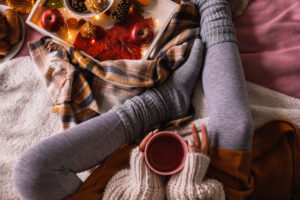 woman wearing leggings holding mug