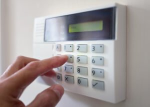 person touching alarm system