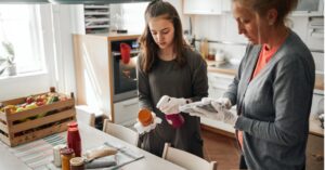 woman pickling vegetables in kitchen