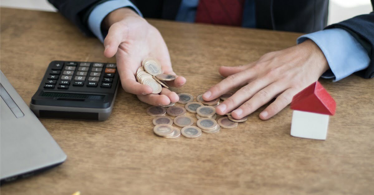 person counting coins on desk