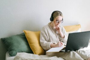 girl sitting at laptop with headphones
