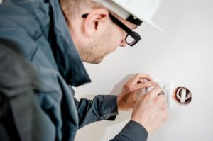 man examining outlet