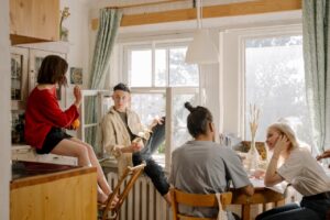 four people sitting in apartment