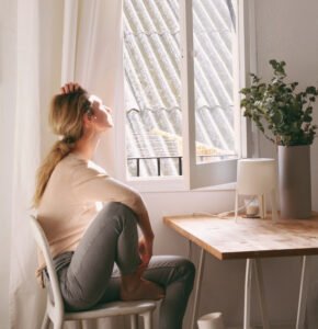 woman looking out window