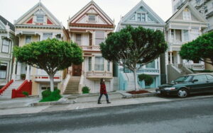 person walking outside of town houses