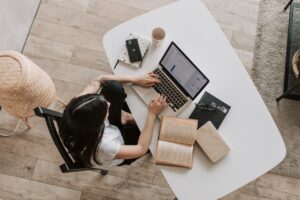 aerial view of woman typing at desk