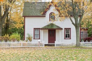 White House with red trim and white picket fence