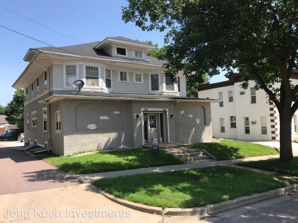 two story house with yard sign