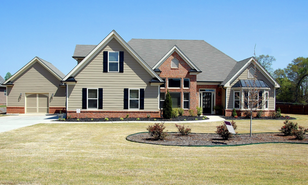 light green house with garage and grass yard