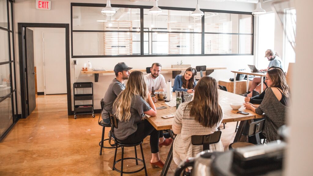 people sitting at a table in an office