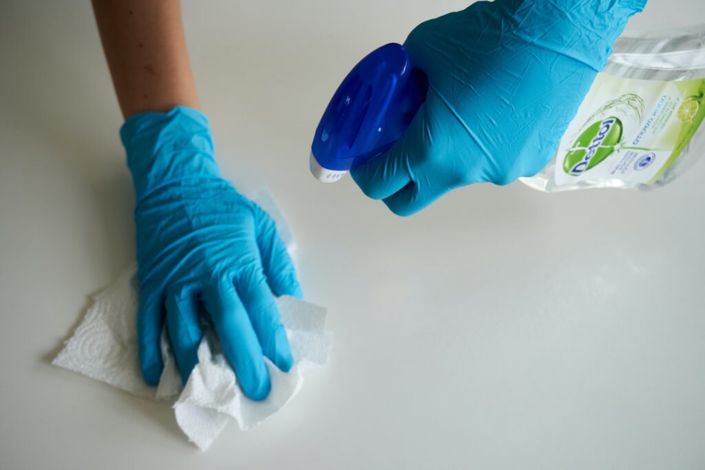 gloved hand wiping counter