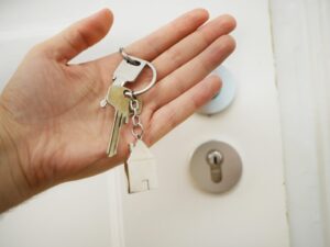 hand holding keys in front of door