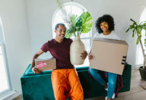couple smiling with moving boxes