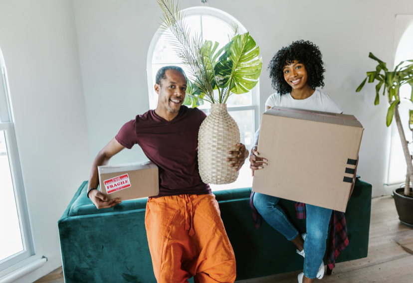 couple smiling with moving boxes