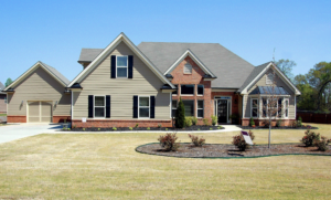 light green house with garage and grass yard