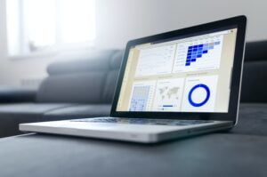 laptop with graphs on the screen