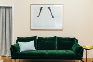 green couch and painting in living room